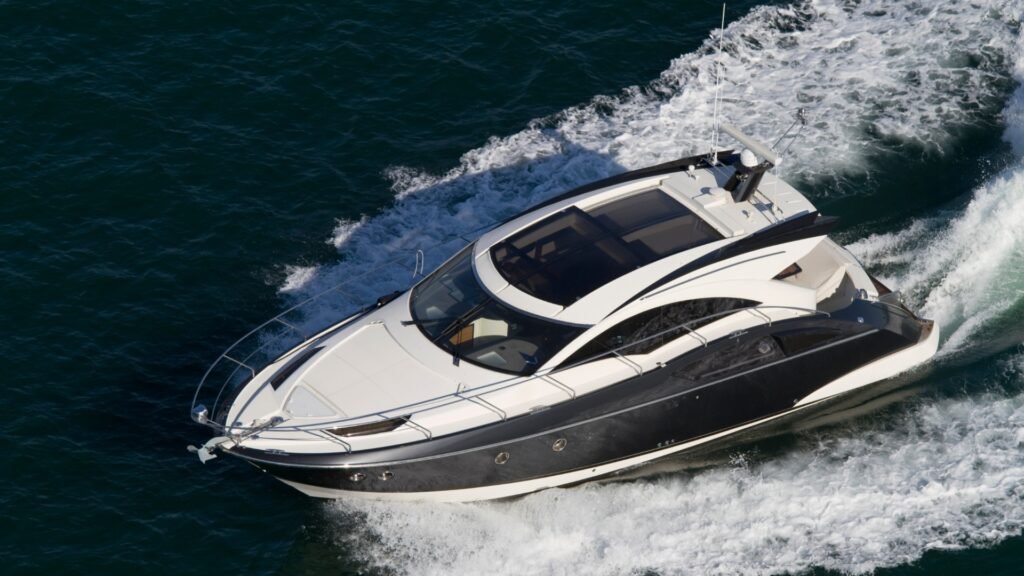 yacht broker photographing a motor yacht for a brokerage listing in Greece